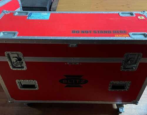 flight case on wheels , fits 2x Martin 575s in red .